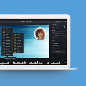 A laptop with a video editing program open on the screen displays editing tools and a circular image of a smiling person, set against a blue background.