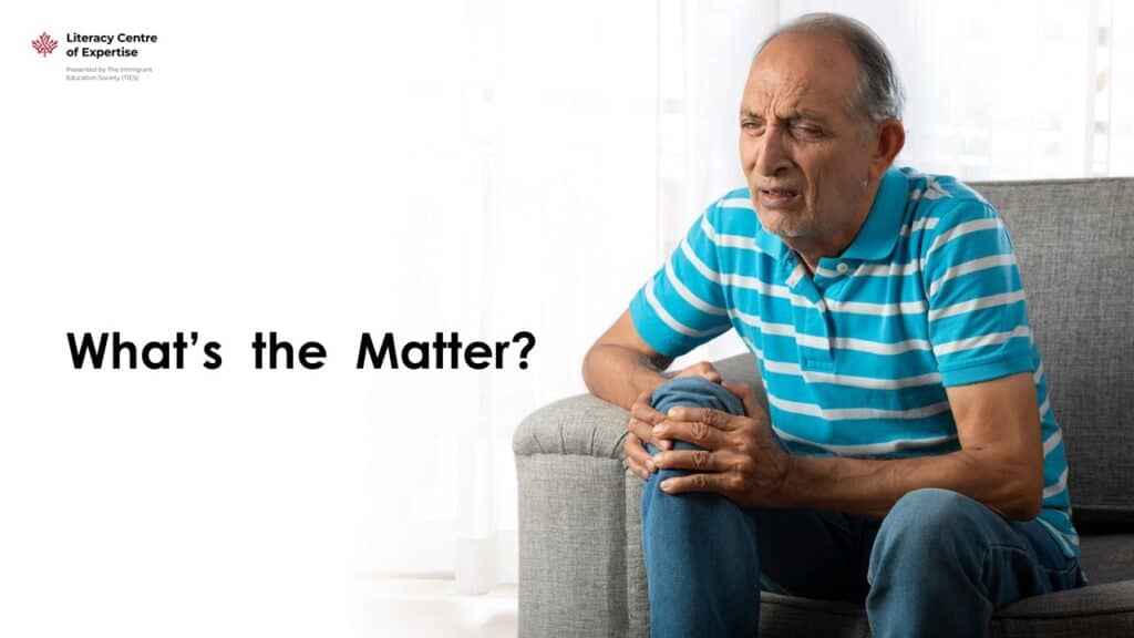 An older man in a striped blue shirt sits on a couch, holding his knee and appearing to be in pain. Text on the image reads, "What's the Matter?" with the Literacy Centre of Expertise logo in the corner.